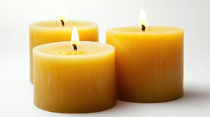 Three Burning Yellow Candles on White Background