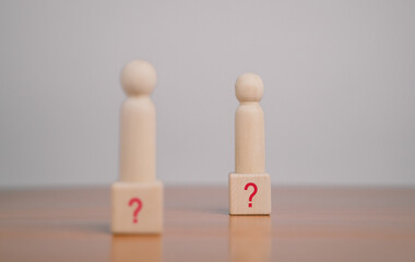What do the wooden blocks in the question mark on the table mean? Teamwork concept, business,...