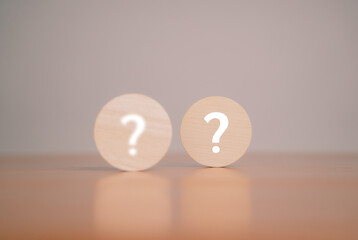 What do the wooden blocks in the question mark on the table mean? Teamwork concept, business,...