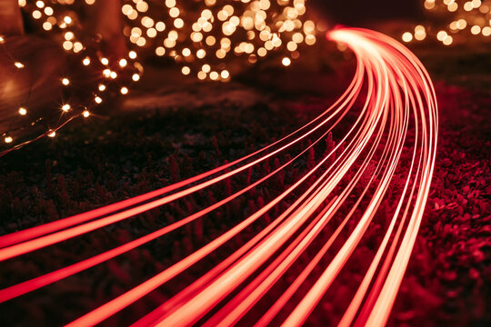 Flowing Red Lights Streaks with Bokeh Festive Lighting for Abstract Backgrounds