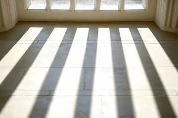 Sunlight streams through a window, casting dramatic parallel shadows across a light beige tiled floor.  A minimalist architectural detail.