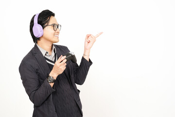 Presenting and Pointing Side Of Handsome Asian Man Holding Game controller and using Headphone Isolated On White Background