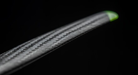 Close-up of Carbon Fiber Blade with Green Tip: High-Resolution Product Photography