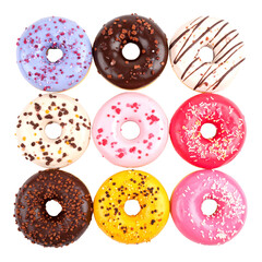 Delicious donuts in different colors on white background