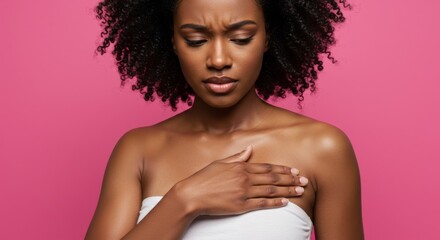 Fototapeta premium Woman with concerned expression and hand on chest against pink background