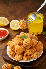 Fried chicken nuggets with lemon juice and ketchup