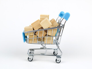 Shopping cart carrying small wooden blocks - isolated on white background