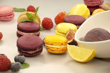 Table filled with array of macaroons and fruits