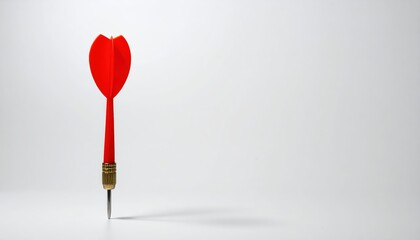 A vibrant red dart with a shiny metallic tip, showcasing its sleek design and aerodynamic shape, poised against a blurred background for emphasis.