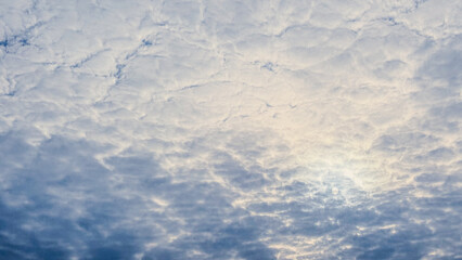 Clouds cracking like fragments in the sun
