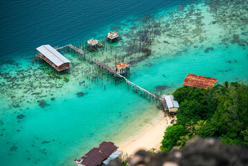 Turquoise ocean sea water white wave splashing deep blue sea. Bird eye view monster wave splash on rock. Tropical sea beach in summer seaside outdoor. Ocean island beautiful dramatic landscape.