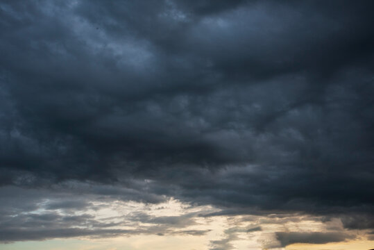 Fototapeta Dramatic dark storm thundercloud rain clouds on black sky background. Dark thunderstorm clouds rainny landscape. Meteorology danger windstorm disaster climate. Dark cloudscape storm disaster gray sky