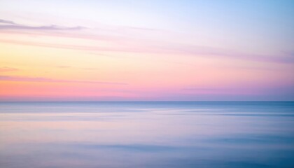 A stunning long exposure captures the sky at dusk, showcasing vibrant hues of orange, pink, and purple, with wispy clouds gracefully streaking across the horizon.