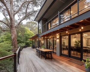 Modern home with outdoor dining deck surrounded by trees