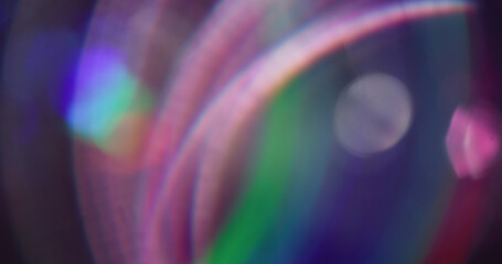 Defocused color flare. Bokeh light. Neon pink green lens gleam optical on blurred with effect abstract background.