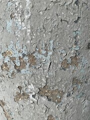 Background with texture of old, peeling gray paint on a concrete wall