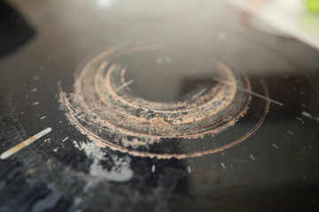 Circular patterns on a worn countertop surface in daylight