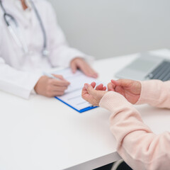 senior woman consulting with doctor in hospital. Elderly patient talking and sharing disease. Doctor listens, asking question and taking note. medical consultation and geriatric Healthcare concept