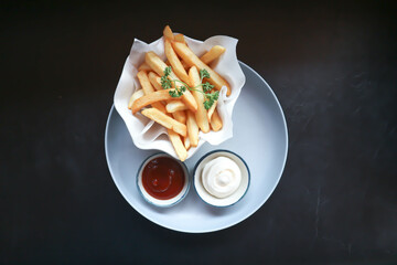  French fries or fried potato , fries with keychup and cheese dip