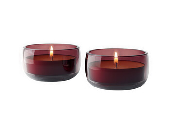 Two lit maroon candles in clear glass holders, each with a visible flame, casting a warm glow, isolated on transparent background