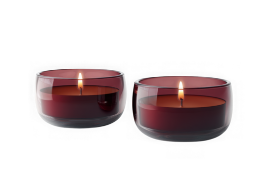 Two lit maroon candles in clear glass holders, each with a visible flame, casting a warm glow, isolated on transparent background