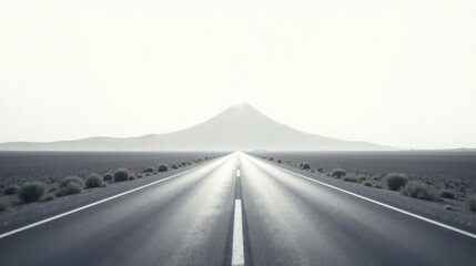 Asphalt ribbon unwinding towards a hazy peak, a journey of endless possibilities under a pale sky