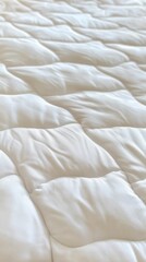 Obraz premium Close-up of a quilted, off-white comforter
