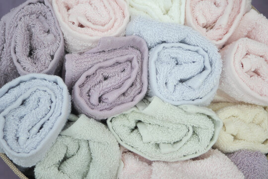 Soft pastel towels arranged neatly in a decorative basket