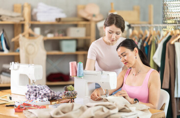 Two seamstresses working on sewing machines in a sewing workshop
