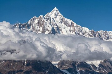 Naklejka premium mountains covered in snow and clouds with a blue sky