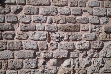 Rustic stone wall with uneven textures in outdoor setting