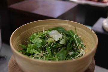 Fresh green kale in ceramic bowl. Selective focus.