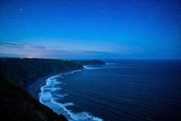 Obraz premium night time view of a beach and ocean with a lighthouse in the distance