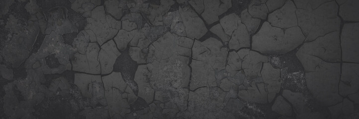 Dark wide panoramic background. Peeling paint on a concrete wall. Faded dark texture of old cracked...