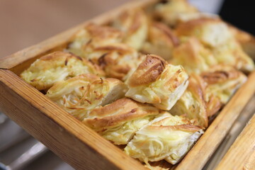 fresh bagels with butter and cheese on plate and cup of coffee on ceramic background