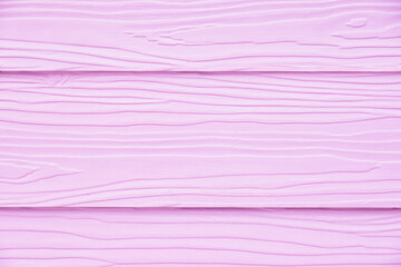 Soft pastel pink wood texture with visible grain lines running horizontally. 