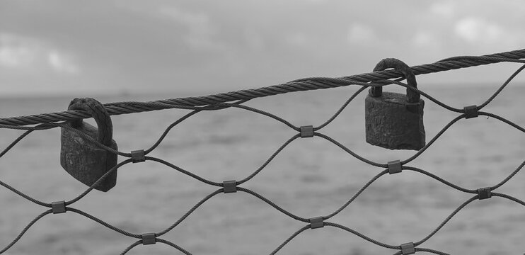 Padlocks Rusty Old Metal Fence Closeup Sea Background Monochrome Horizontal Mood. Symbolism - Powered by Adobe