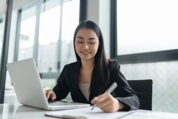 Beautiful&nbsp;confident asian business woman working with laptop Hands typing  keyboard. Professional investor working new start up project. business planning in office. Technology business