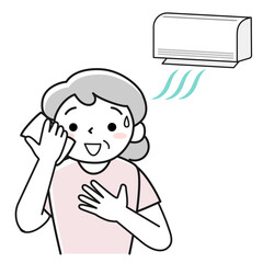 冷房で暑さをしのぐ笑顔の高齢女性