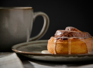 Cinnamon rolls on plates with coffee