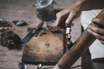 A person man sits alone in a dark room smoking marijuana, Drug addict man or drug dealer prepares heroin. international Day against Drug Abuse and Illicit Trafficking