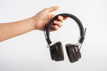 HeadPhones in hand, Headphones isolate on white. Wireless headphones in brown.