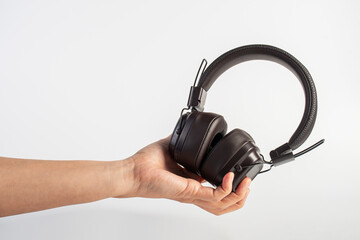 HeadPhones in hand, Headphones isolate on white. Wireless headphones in brown.