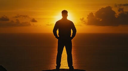 Silhouette of a person standing on a cliff at sunset, gazing over the ocean horizon