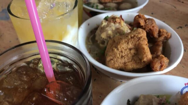Meatballs with young bone topping, and sweet iced tea look very delicious