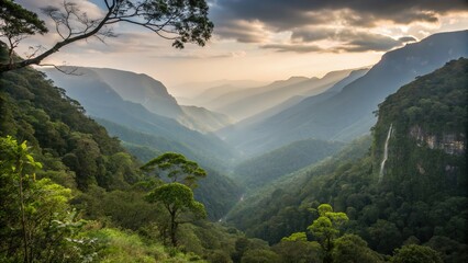 Misty mountain range with lush forest, a waterfall, and golden light