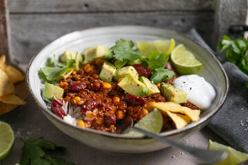 Vibrant and appetizing Mexican-inspired bowl with fresh avocado, chili, rice, and lime — perfect for promoting healthy, colorful cuisine and gourmet meals