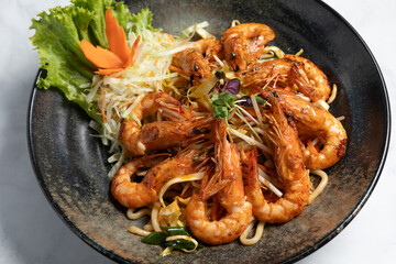 Noodles with shrimp on plate