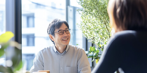 Business scene with a woman and a man talking peacefully.