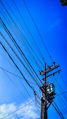 Fototapeta premium a power lines and wires with blue sky